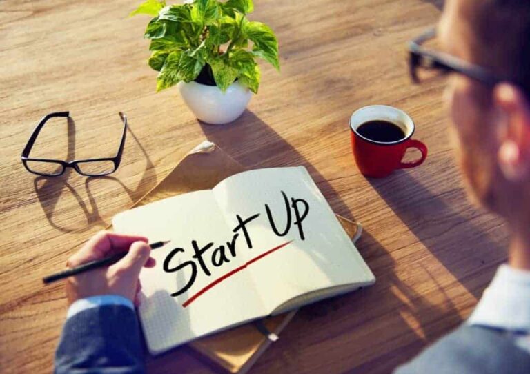 Man with notepad and startup in text on it